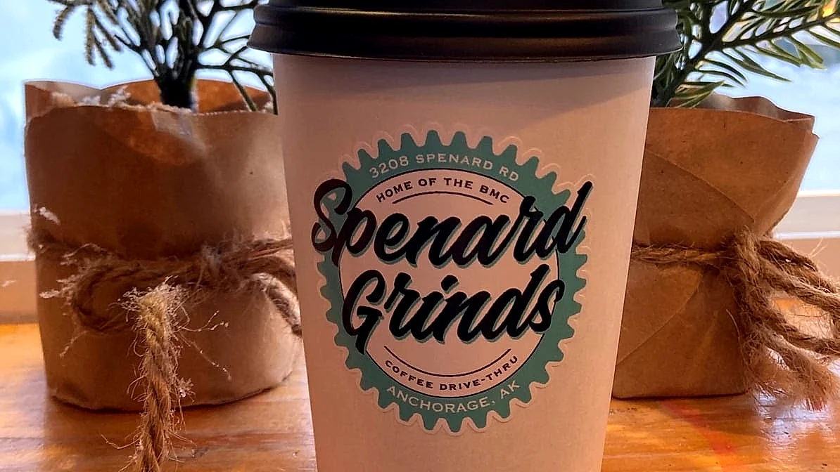 A hot Spenard Grinds drink in a branded cup